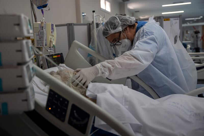 A health worker treats a Covid-19 patient in the intensive care unit of a hospital in Marica, Brazil. AP