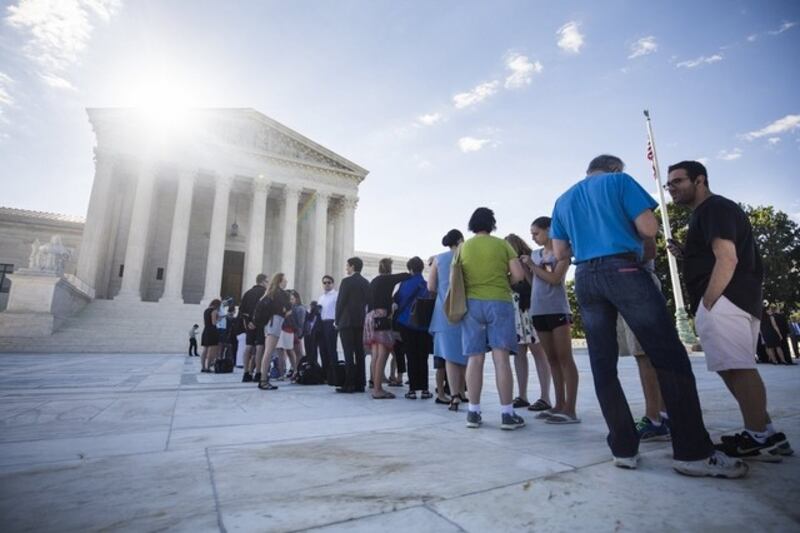 People gathered outside the US supreme court in Washington as the justices prepared to deliver a ruling on president Donald Trump’s travel ban on visitors to the US from six predominantly Muslim countries on June 26, 2017. Jim Lo Scalzo / EPA