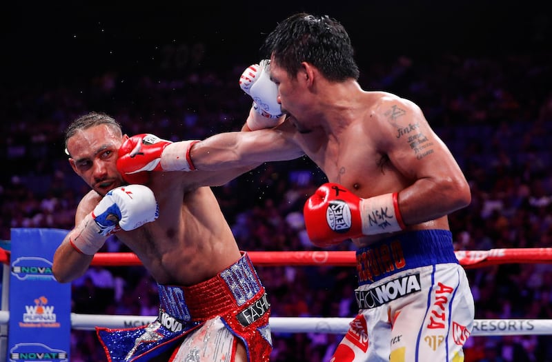 Manny Pacquiao, right, and Keith Thurman exchange punches in the 10th round. AP Photo