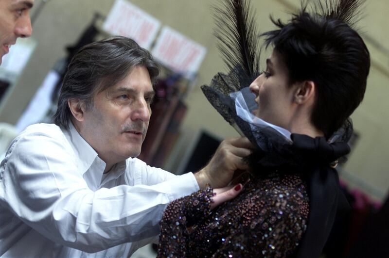 FILE PHOTO: Italian designer Emanuel Ungaro makes last-minute preparations backstage prior to the presentation of his 2001/2002 autumn-winter Haute Couture collection in Paris, France July 9, 2001. REUTERS/Philippe Wojazer/File Photo