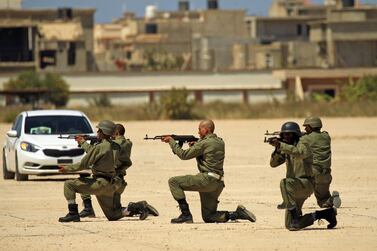 Fighters from the Libyan National Army attend their graduation ceremony at a military academy in Libya's eastern city of Benghazi on April 18, 2019. AFP