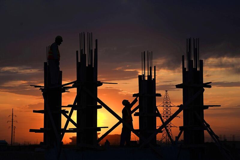 Afghanistan is this week's clear front-runner for best business pictures: here, labourers work at a construction site during sunset in Mazar-i-Sharif. (Farshad Usyan / AFP /  April 22, 2014)