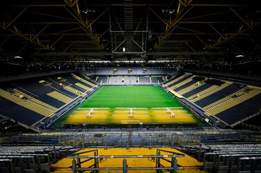 The empty stadium Signal Iduna Park of the Bundesliga club Borussia Dortmund is pictured in Dortmund, western Germany, on May 5, 2020, due to the spread of the novel coronavirus COVID-19. German football is waiting for the green light as during Chancellor Angela Merkel's crucial meeting with the Presidents of the Lander (regional states) on May 6, 2020 will be decided whether or not to allow the Bundesliga to resume, behind closed doors and on the basis of a draconian health protocol. / AFP / Ina FASSBENDER
