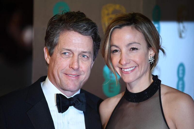 (FILES) In this file photo taken on February 12, 2017 British actor Hugh Grant (L) and Swedish producer Anna Eberstein (R) pose upon arrival at the BAFTA British Academy Film Awards at the Royal Albert Hall in London on February 12, 2017. Veteran bachelor Hugh Grant, star of a string of romantic comedies including "Four Weddings and a Funeral", is finally getting married for the first time at the age of 57 to his Swedish girlfriend, 39-year-old television producer Anna Eberstein. / AFP / Justin TALLIS
