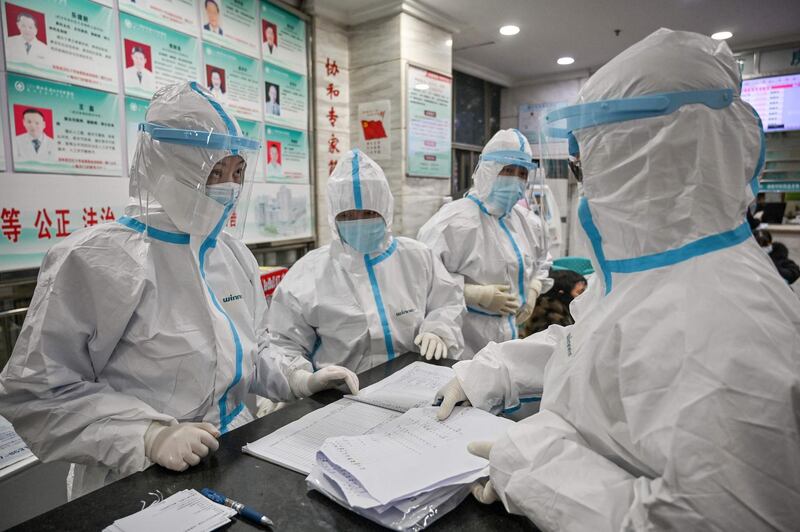 Medical staff members wearing protective clothing to help stop the spread of a deadly virus which began in the city, work at the Wuhan Red Cross Hospital.  AFP