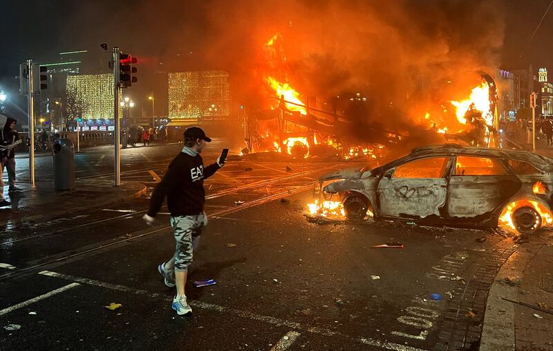 A car and bus burn at the junction of Bachelors Walk and the O'Connell Bridge in Dublin. AFP