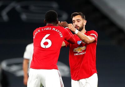 Manchester United's Bruno Fernandes (right) celebrates scoring his side's first goal of the game from the penalty spot with Paul Pogba during the Premier League match at the Tottenham Hotspur Stadium, London. PA Photo. Issue date: Friday June 19, 2020. See PA story SOCCER Tottenham. Photo credit should read: Matt Childs/PA Wire/NMC Pool. RESTRICTIONS: EDITORIAL USE ONLY No use with unauthorised audio, video, data, fixture lists, club/league logos or "live" services. Online in-match use limited to 120 images, no video emulation. No use in betting, games or single club/league/player publications.