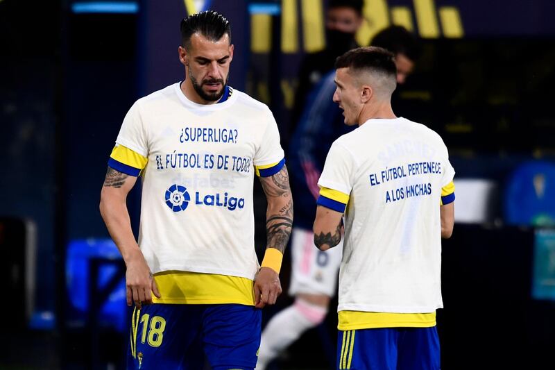 Cadiz's Alvaro Negredo, left, and Salvi Sanchez wear t-shirts that read in Spanish: "Super League? Soccer belongs to everyone" and "Soccer belongs to supporters" prior to the match. AP