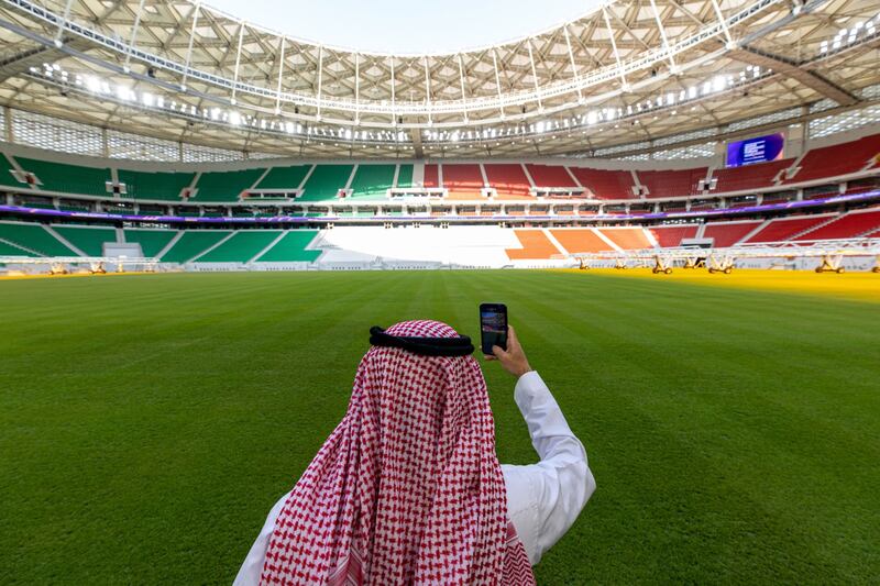 A visitor takes a photograph at the Al Thumama Stadium in Doha. The stadium will be a venue for the 2022 World Cup in Qatar later in the year. Bloomberg