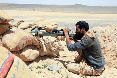 A fighter loyal to Yemen’s government holds a position against Houthi rebels in Marib. AFP