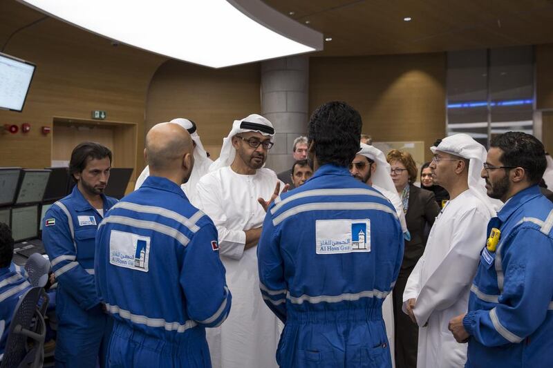 Sheikh Mohammed bin Zayed, centre, Crown Prince of Abu Dhabi and Deputy Supreme Commander of the UAE Armed Forces, speaks with Al Hosn gas employees. Ryan Carter / Crown Prince Court - Abu Dhabi