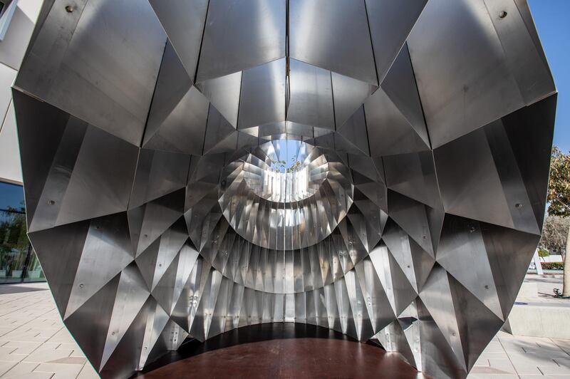 'Haweia consists of a smooth exterior facade of folded aluminium that is shaped like an oculus. The interior features reflective surfaces and fins framed to offer different perspectives. Courtesy NYU Abu Dhabi