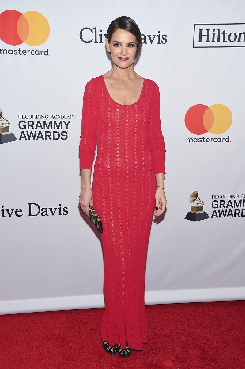 Katie Holmes sat next to partner Jamie Foxx at the  2018 Pre-Grammy Gala And Salute To Industry Icons, and wore a simple striped red dress for the occasion. Evan Agostini / AP