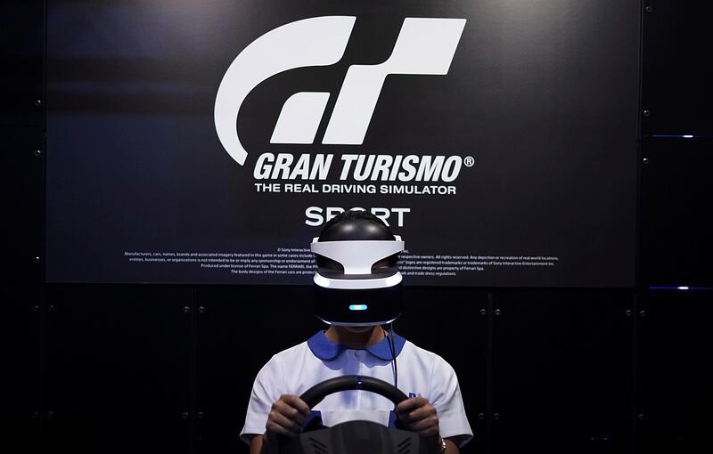 A woman tries out a PlayStation VR headgear device at the Tokyo Game Show in Chiba, near Tokyo. Eugene Hoshiko / AP Photo