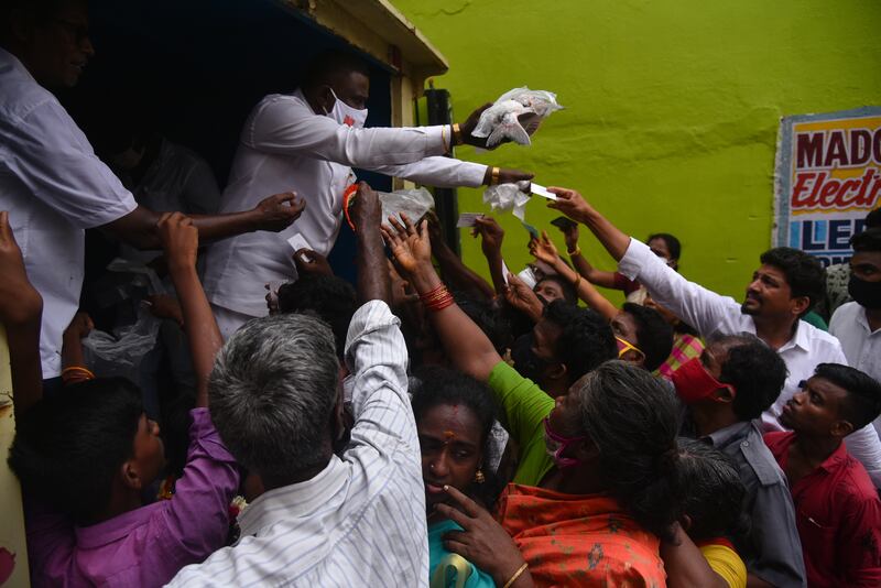 Bharatiya Janata Party workers distribute fish among the people during the birthday celebrations in Chennai. EPA