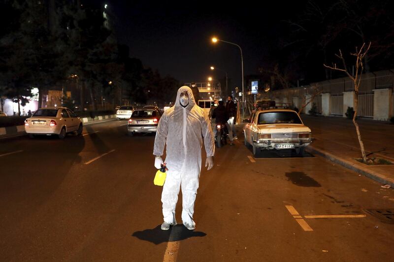 A Revolutionary Guard member takes part in disinfecting the city in Tehran, Iran, March 4. AP