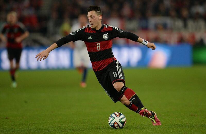 Mesut Ozil and Germany beat Chile 1-0. They'll play in Group G at the 2014 World Cup with Portugal, Ghana and United States. Patrik Stollarz / AFP