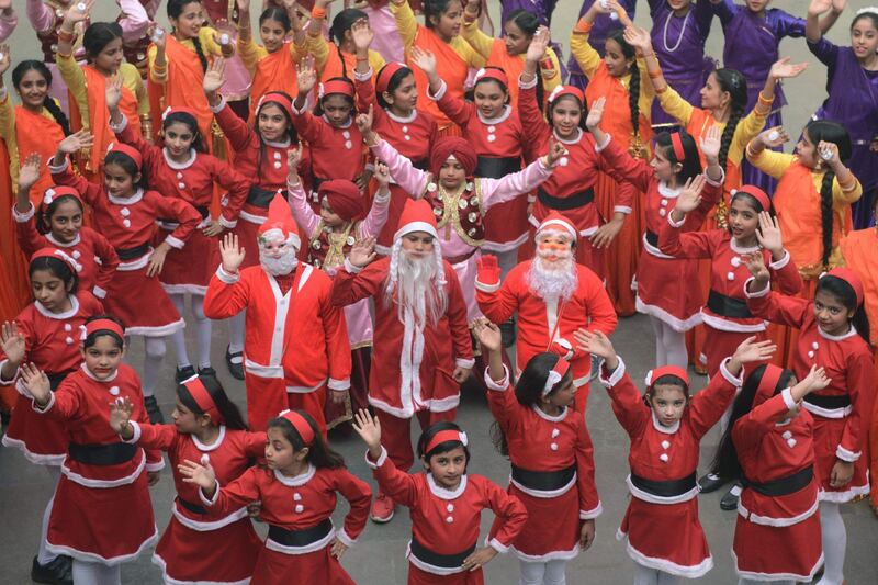 Indian children dressed as Santa Claus perform during a Christmas function at the Shri Ram Ashram public school in Amritsar. AFP