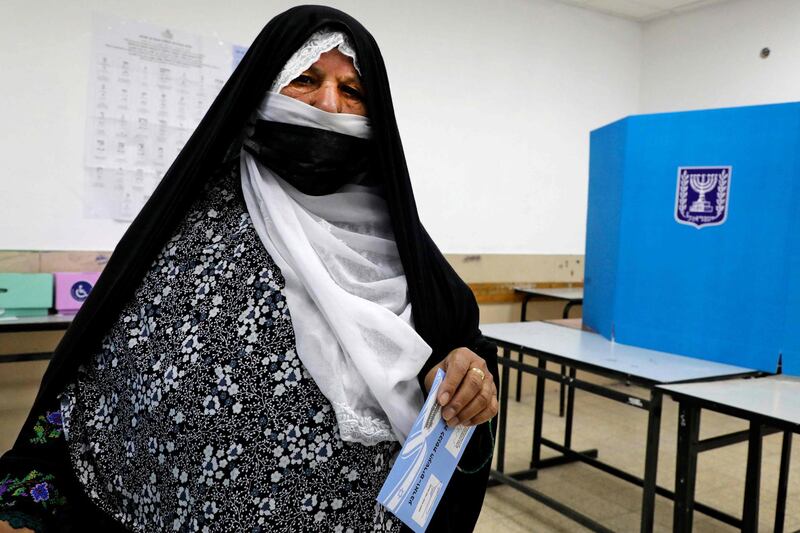 An Israeli Arab woman casts her ballot in the Bedouin town of Rahat. AFP