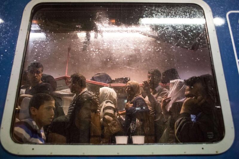 Refugees crowd on to a train travelling from Gyor to Hegyeshalom, Hungary, on Saturday. Croatia has bussed hundreds of people to its border with Hungary, increasing tensions between the two countries over the handling of migrants. Vladimir Simicek/AFP

