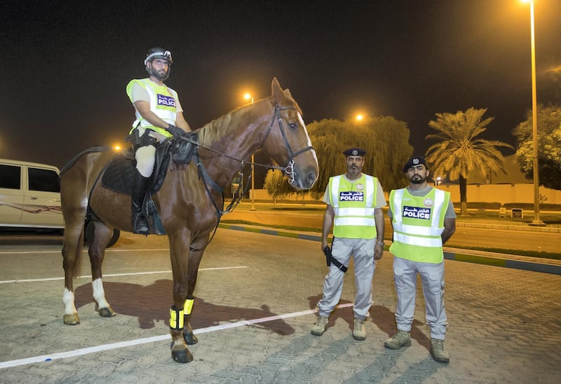 Abu Dhabi, United Arab Emirates- Police officers preparing to do patrol in a horse in Al Mushrif.  Leslie Pableo for The National for Haneen Dajani's story