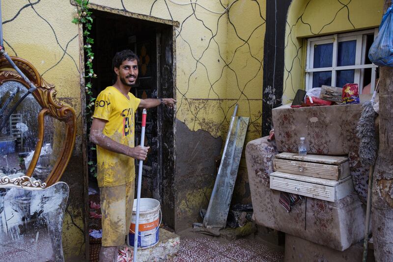 Khalifa Al Balushi, a resident of Oman's Al Khaburah town, points to the level floodwaters reached at his house. All photos: Tara Atkinson for The National