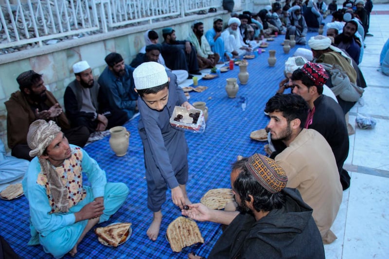Afghans wait to break their Ramadan fast at a mosque during the holy month, in Kandahar. EPA