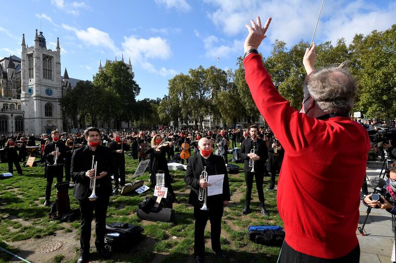 A conductor leads the musicians. Reuters