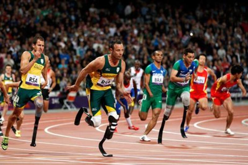 Arnu Fourie hands over to Oscar Pistorius in the final leg of their 4x100m relay at London 2012