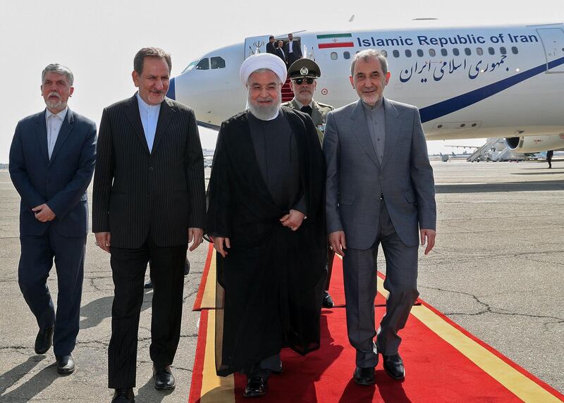 A handout picture provided by the Iranian presidency on September 27, 2019 shows President Hassan Rouhani (C) walking with Vice President Eshagh Jahangiri (2nd-L) and Ali Akbar Velayati (R), senior adviser to Iran's Supreme Leader on International Affairs, upon disembarking from his plane at Mehrabad International Airport in the capital Tehran during a welcome ceremony after the 74th United Nations General Assembly in New York.  - === RESTRICTED TO EDITORIAL USE - MANDATORY CREDIT "AFP PHOTO / HO / IRANIAN PRESIDENCY" - NO MARKETING NO ADVERTISING CAMPAIGNS - DISTRIBUTED AS A SERVICE TO CLIENTS ===
 / AFP / Iranian Presidency / - / === RESTRICTED TO EDITORIAL USE - MANDATORY CREDIT "AFP PHOTO / HO / IRANIAN PRESIDENCY" - NO MARKETING NO ADVERTISING CAMPAIGNS - DISTRIBUTED AS A SERVICE TO CLIENTS ===
