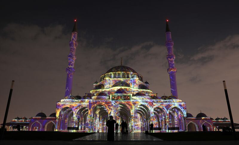 People view the illuminated Sharjah Masjid. EPA