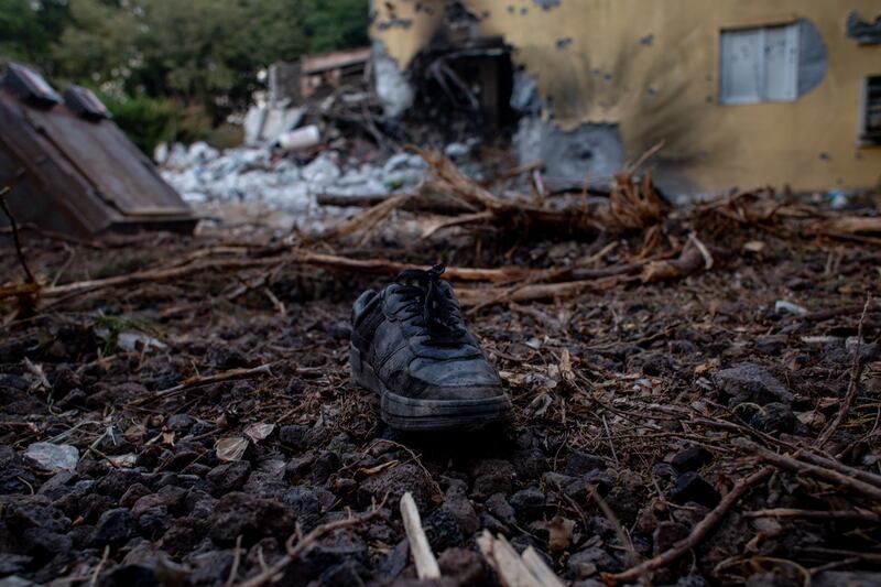 A boot lies on the ground outside a damaged house in Be'eri, Israel. EPA