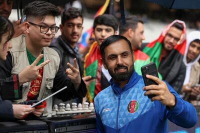 Afghanistan's Mohammad Nabi poses for selfies at the MCG after rain forced the mach against Ireland to be abandoned. AFP