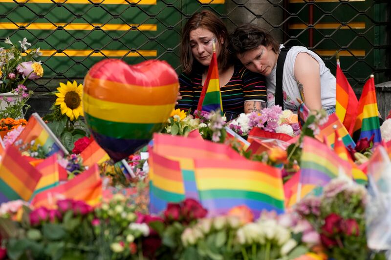 People comfort each other at the scene of a shooting in central Oslo, Norway. A gunman who opened fire in Oslo’s nightlife district has killed two people and left more than 20 others injured during the LGBTQ Pride festival in Norway's capital. AP Photo