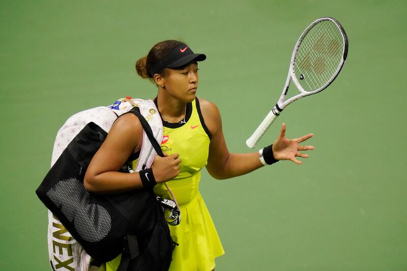Naomi Osaka, of Japan, tosses her racket to herself after losing.  AP