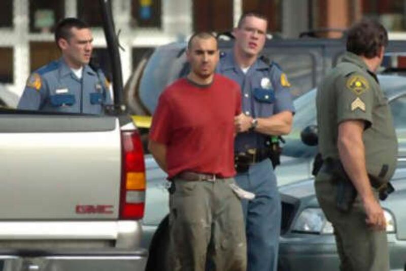 Washington State Troopers and a Skagit County Sheriff's Deputy lead shooting suspect, Isaac Zamora, 28, to the county jail, Tuesday Sept. 2, 2008 in Mount Vernon, Wash., after he led authorities on a high speed chase from Alger, Wash. The Washington State Patrol says six people are dead and two are wounded after a shooting rampage. Authorities say Zamora turned himself in after the shootings Tuesday afternoon. A sheriff's deputy is among the dead. (AP Photo/The Skagit Valley Herald, Scott Terrell) *** Local Caption ***  WAMVE101_Shooting_Rampage.jpg