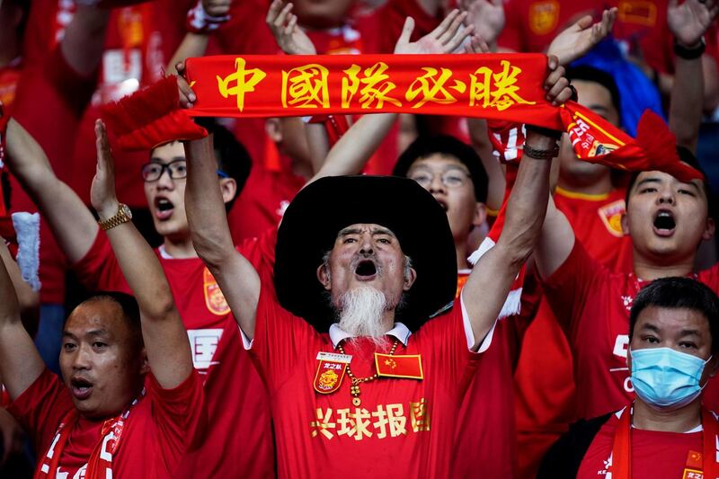 FILE PHOTO: Soccer Football - World Cup - Asia Qualifiers - Second Round - Group A - Guam v China - Suzhou Olympic Sports Center, Suzhou, Jiangsu province, China - May 30, 2021 China fans cheer before the match. REUTERS/Aly Song/File Photo