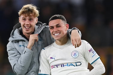 WOLVERHAMPTON, ENGLAND - MAY 11: Phil Foden and Cole Palmer of Manchester City celebrate their side's victory after the Premier League match between Wolverhampton Wanderers and Manchester City at Molineux on May 11, 2022 in Wolverhampton, England. (Photo by Shaun Botterill / Getty Images)