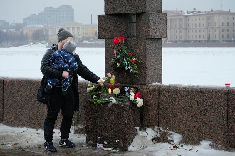 Flowers are placed at a memorial to Alexei Navalny in St Petersburg, Russia. AP