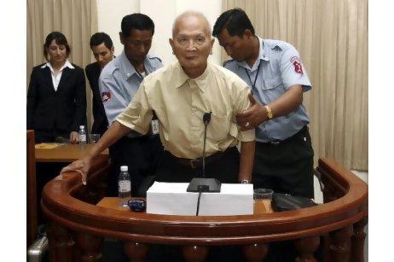The most senior surviving leader of the Khmer Rouge, 'Brother Number Two' Nuon Chea (centre), is helped up by police officers at the Extraordinary Chambers in the Court of Cambodia. Chor Sokunthea Reuters