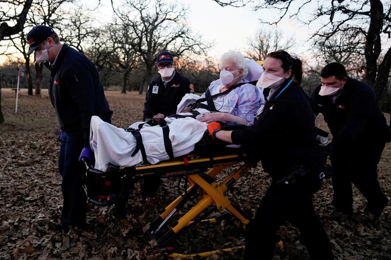 REACT EMS paramedics prepare to transport an 87-year-old woman who had been exposed to the coronavirus disease and was experiencing symptoms in Meeker, Oklahoma, US. Reuters