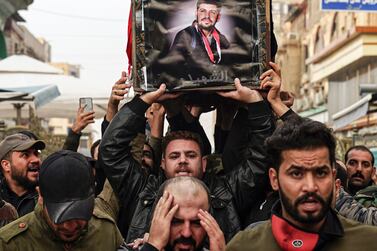 Iraqi mourners carry the coffin of a protester and citizen journalist, who was killed during a demonstrations the previous day in Baghdad, during his funerary procession in the central holy Shia city of Najaf on December 7, 2019 AFP