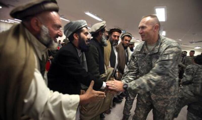 A US Army officer greets Shinwari tribal leaders during a meeting in Nangarhar province on January 27, 2010.