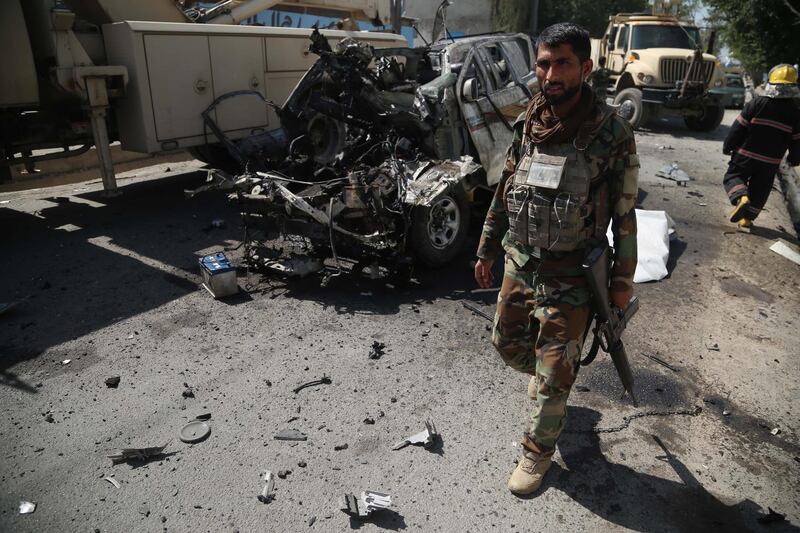 epa09161385 Afghan security officials inspect the scene of a bomb blast that targeted a vehicle of Afghan National Army, in Jalalabad, Afghanistan, 26 April 2021. At least three Afghan soldiers and four civilians were injured in the incident. General Scott Miller the commander of the US forces in Afghanistan on 25 April, warned of a tragedy if the Taliban returns to violence instead of sticking to the ongoing peace process. Miller's comments came days before the start of the process of withdrawing forces of the US-led coalition from Afghanistan on 01 May, after almost two decades of war.  EPA/GHULAMULLAH HABIBI