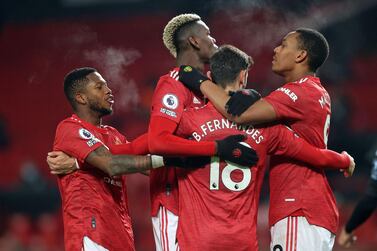 Manchester United midfielder Bruno Fernandes celebrates with teammates after scoring their second goal from the penalty spot against Aston Villa. AFP