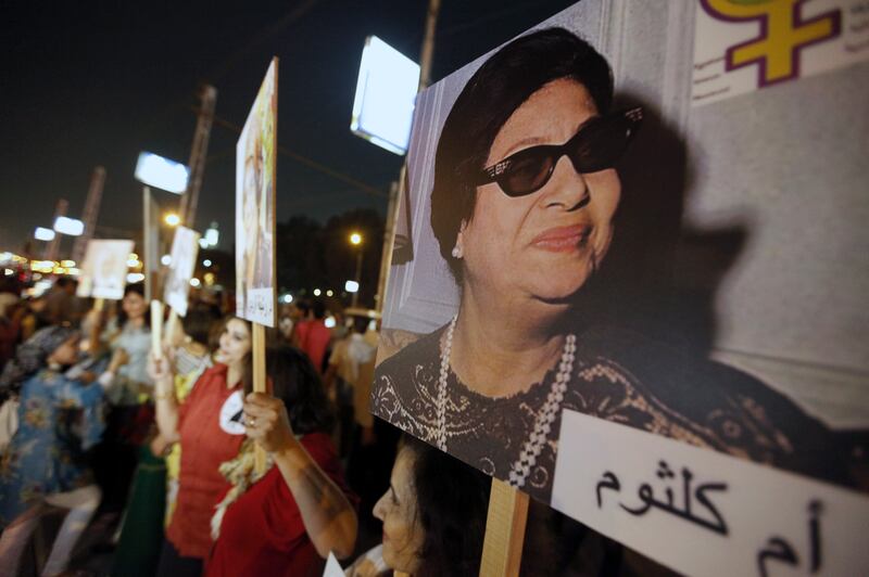 Egyptian women carry pictures of late singer Umm Kulthum at a rally in Cairo to support women's rights and protest against harassment and child marriage. Reuters