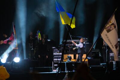 Paul McCartney waves the Ukrainian flag while performing on the Pyramid stage at Glastonbury Festival. AP