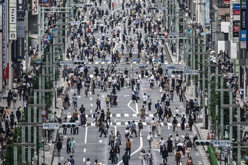 People walk on a street in Tokyo.  Some 260 new cases COVID-19 coronavirus infections were recorded in the Japanese capital. AFP