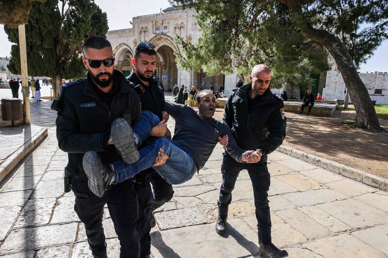 Israeli police detain a Palestinian man at Al Aqsa Mosque compound in Jerusalem on Wednesday. AFP