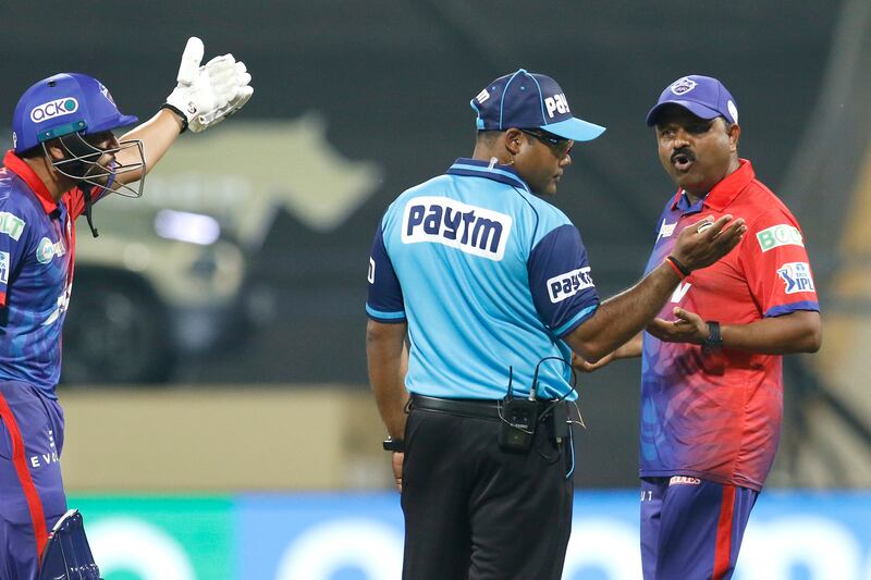 Delhi Capitals assistant coach Pravin Amre talks with the umpire during the chase against Rajasthan Royals at the Wankhede Stadium in Mumbai on Friday, April 22, 2022. Sportzpics for IPL